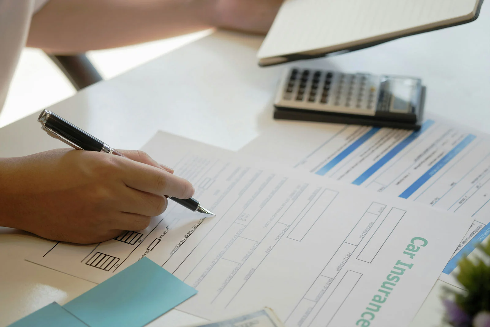 Insurance application documents being reviewed, representing TBFS’s specialised application processing project